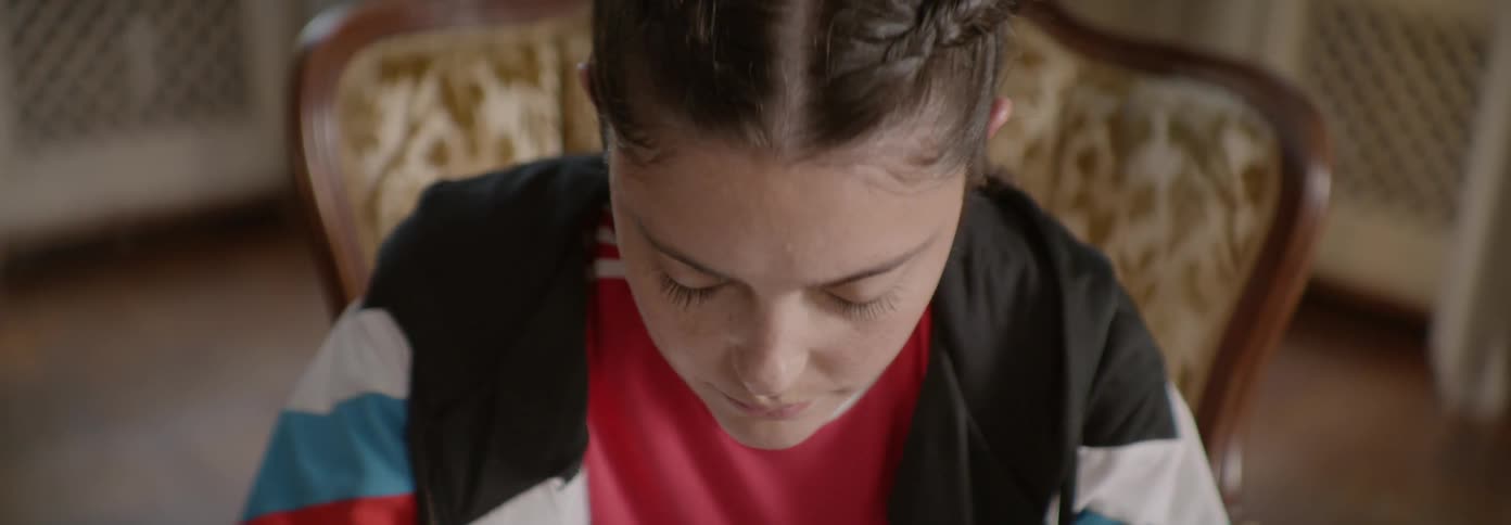 Woman nods while sitting in a chair