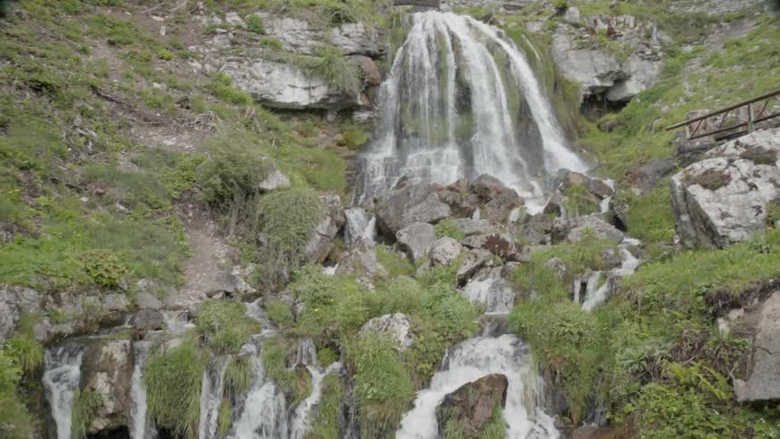 A waterfall flows over a cliff