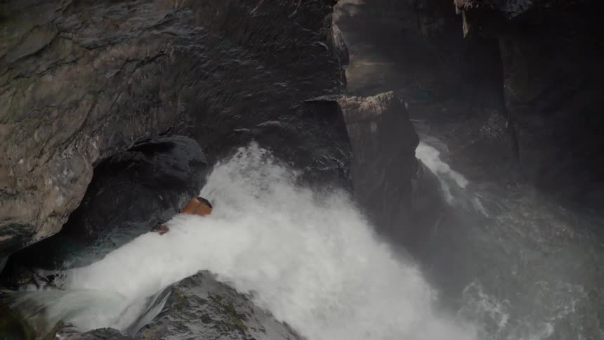 A waterfall flows over rocks