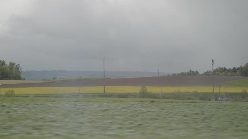 Traveling past colorful farmland on a cloudy day