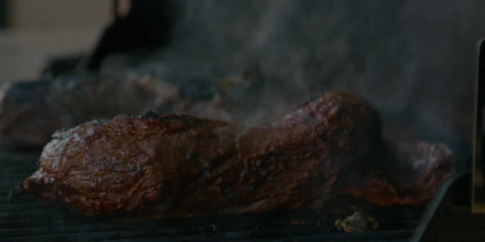 A steak is cooked on a grill