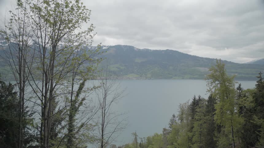 Clouds over hills forest and lake