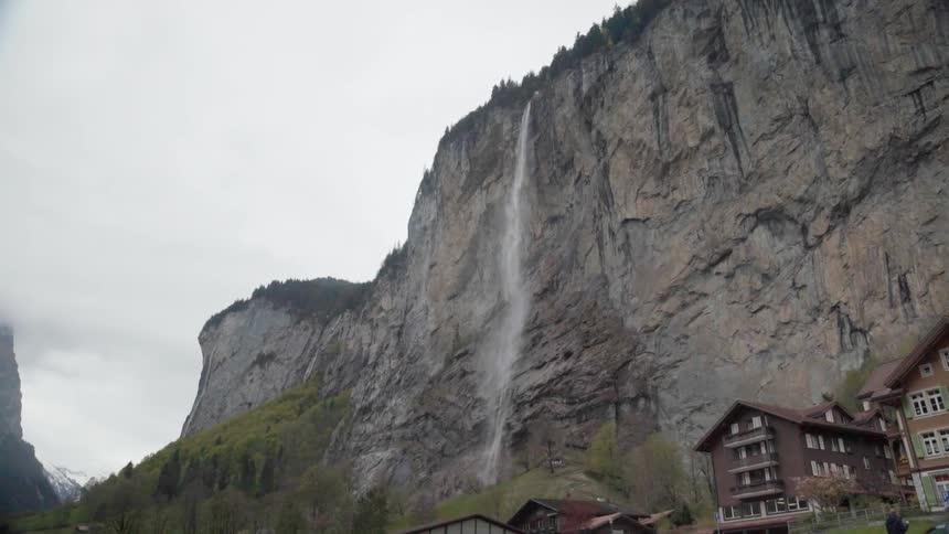 A waterfall flows over a tall cliff