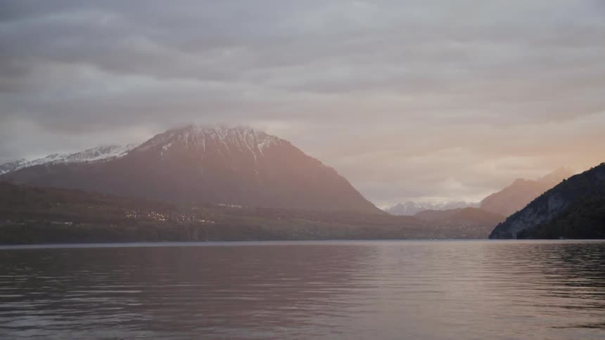 Lake waters flow next to a mountain