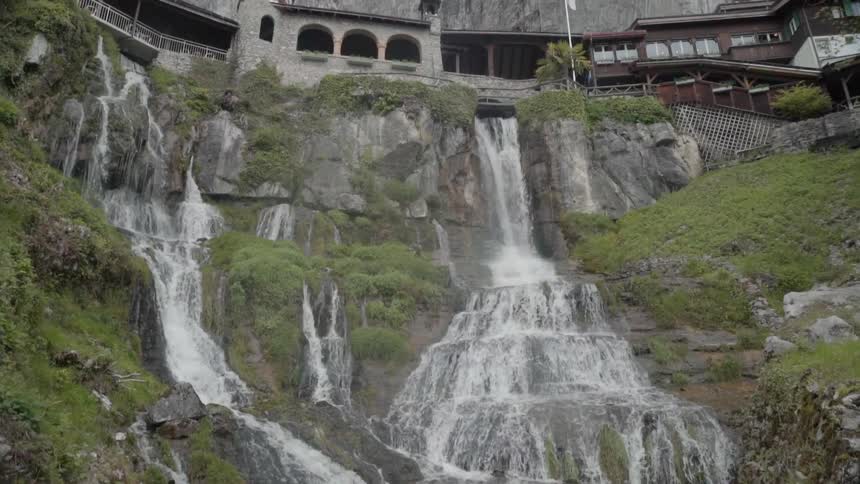 Water splashes down falls into a stream below