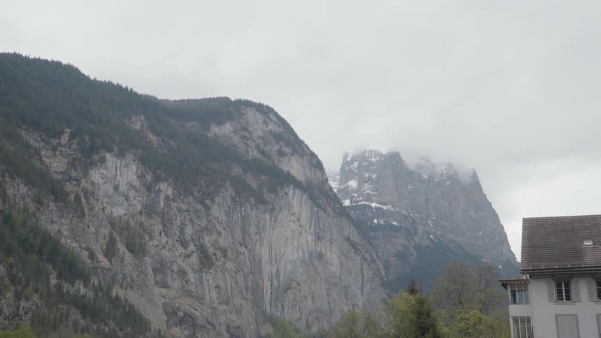 Clouds float above mountain peaks