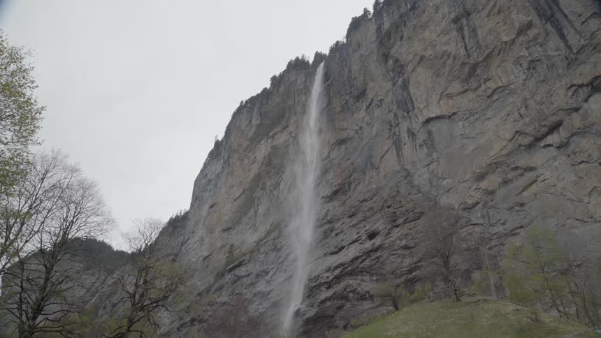 A waterfall flows over a tall cliff