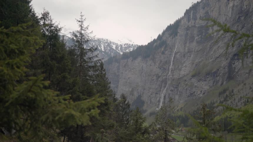 Trees cover the valley between mountains