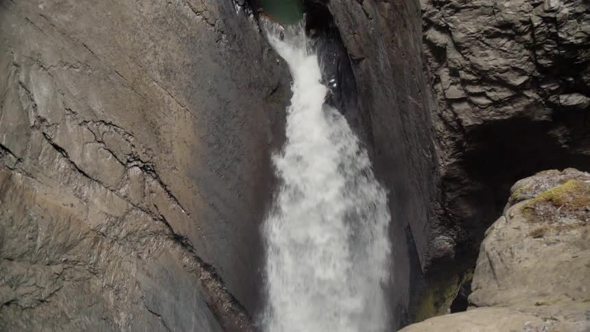 A waterfall flows over rocks