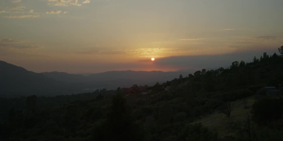 The sun shines above the mountain range