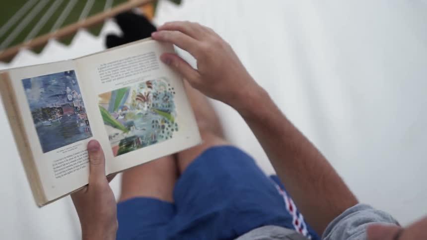 A person is flipping pages through a book