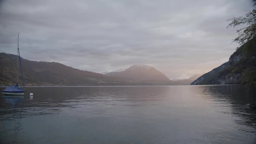 Lake waters flow next to a mountain