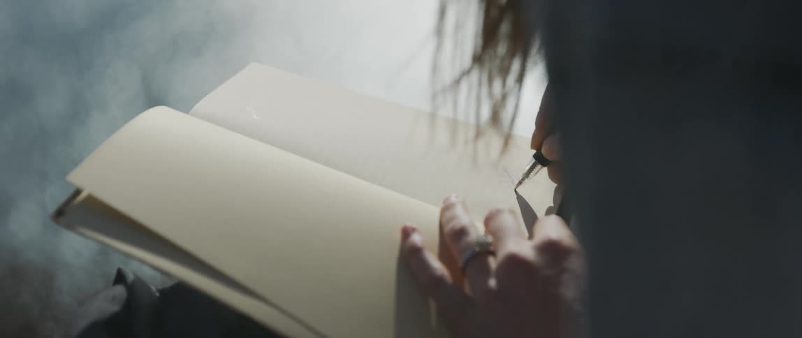 Woman writes in a notebook