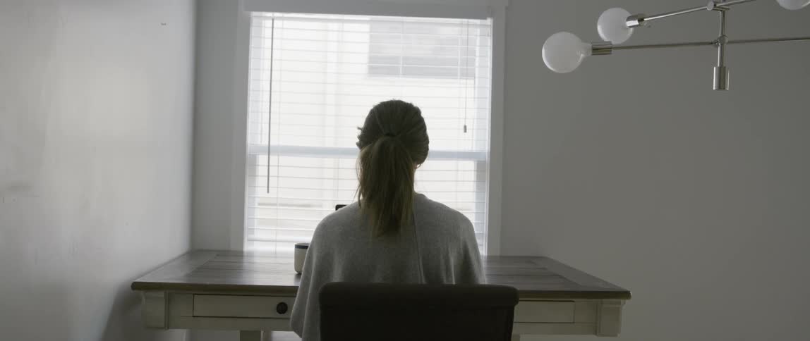 Woman sits at a desk