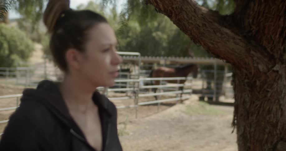 Woman stands on a ranch