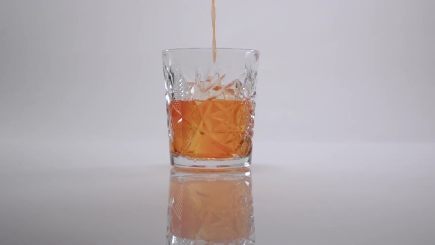 A drink is poured into a glass