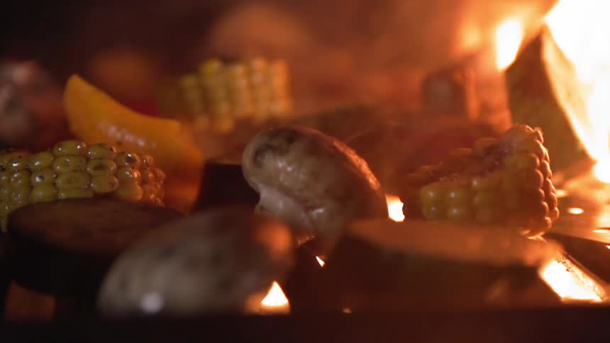 Vegetables are cooked on a grill