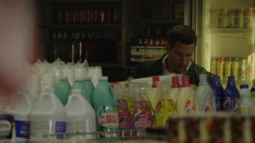 A man is looking at items in the store