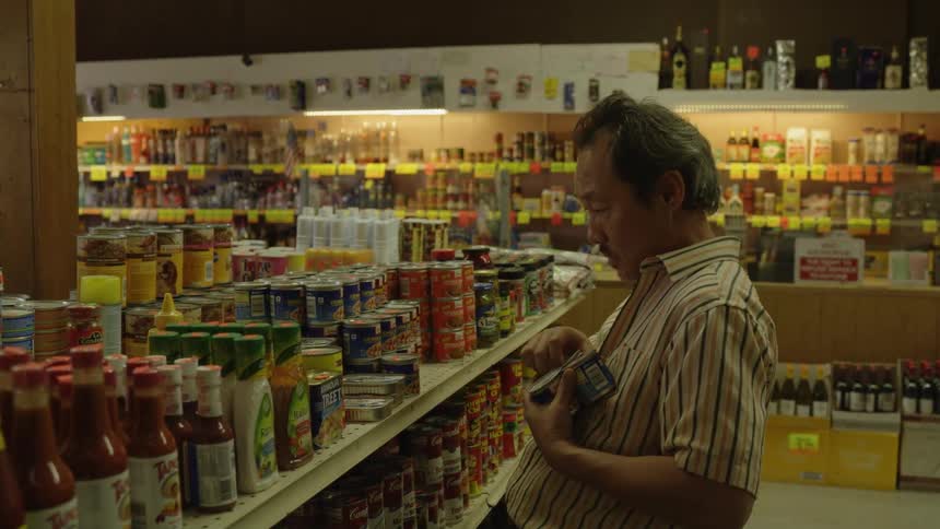 Man puts items on a shelf in a store