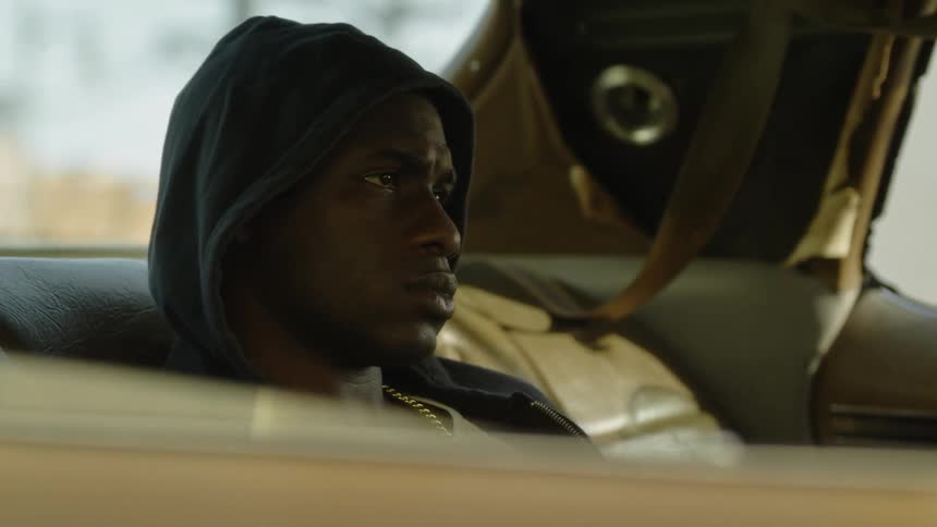 Man sits in the backseat of a car