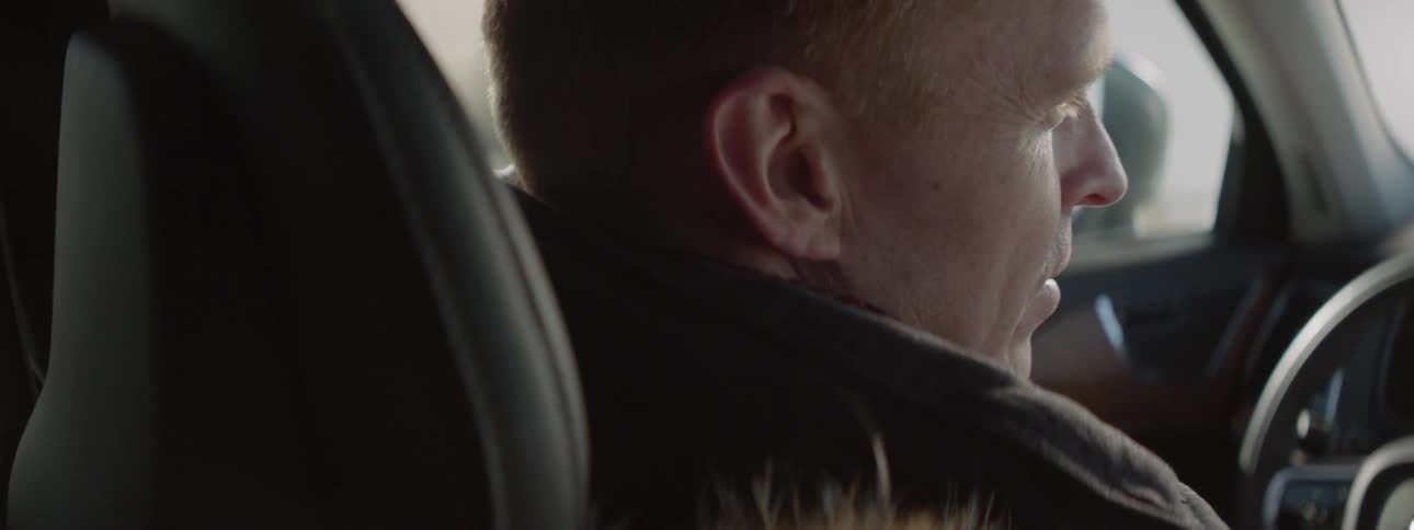 Man talks while sitting in a parked car