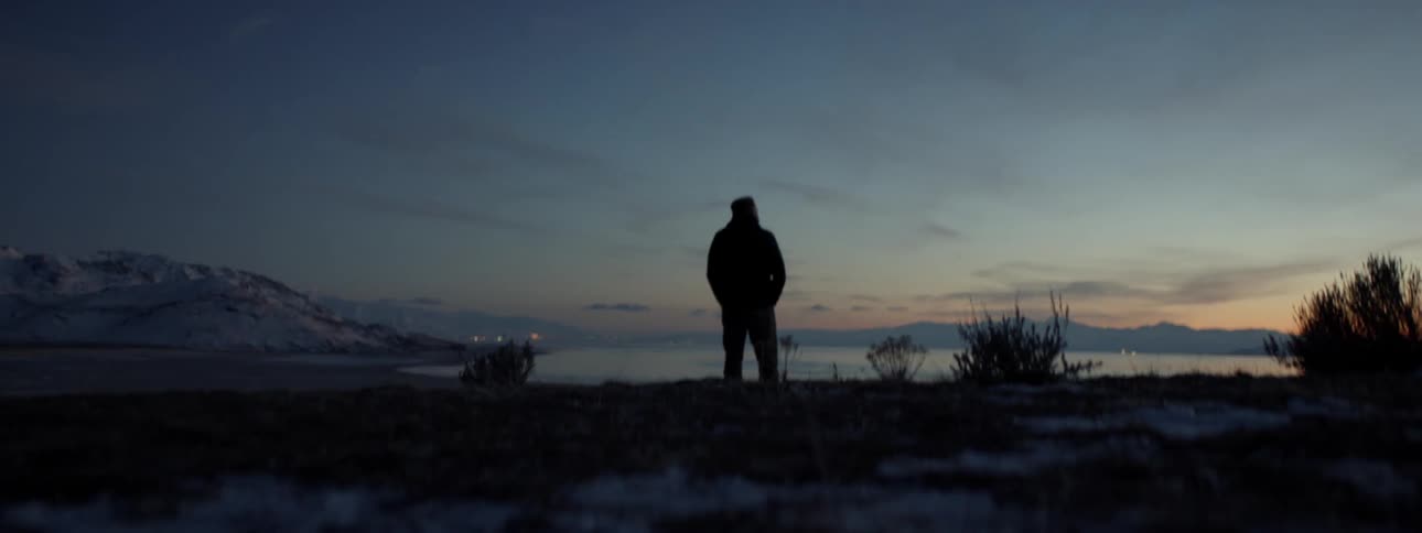 Person walks outside on the beach at sunset