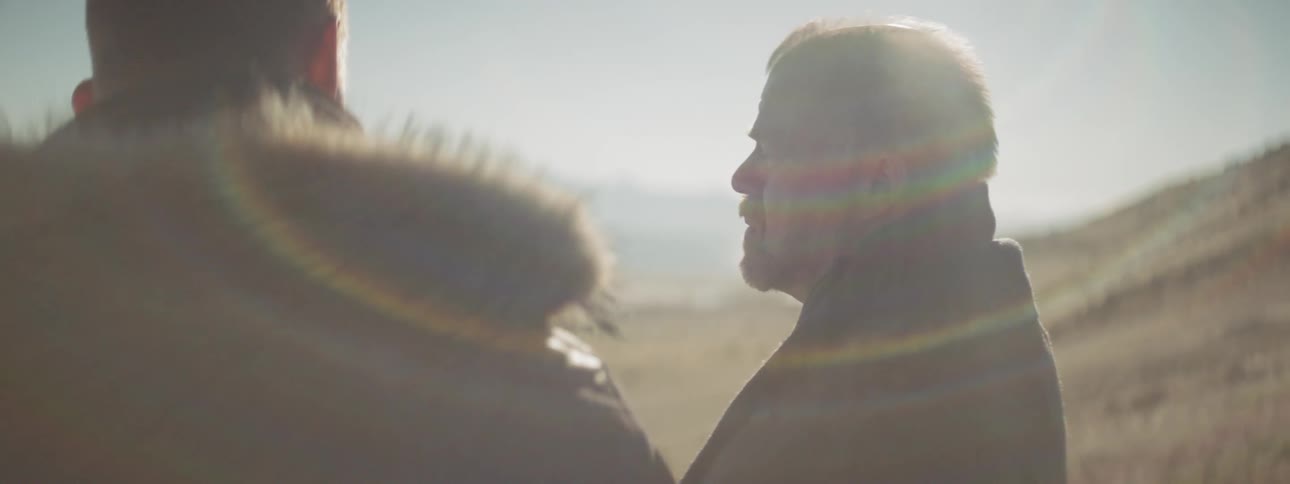 Two men talking outside in the afternoon