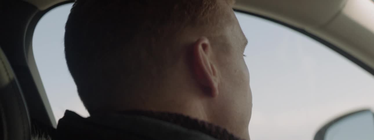 Man sits in a car looking out