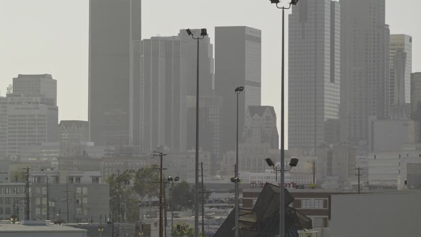 The buildings ahead are covered with fog