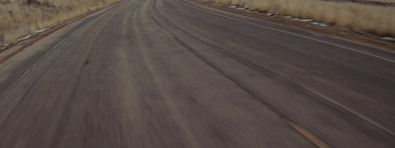 A car travels on a rural road