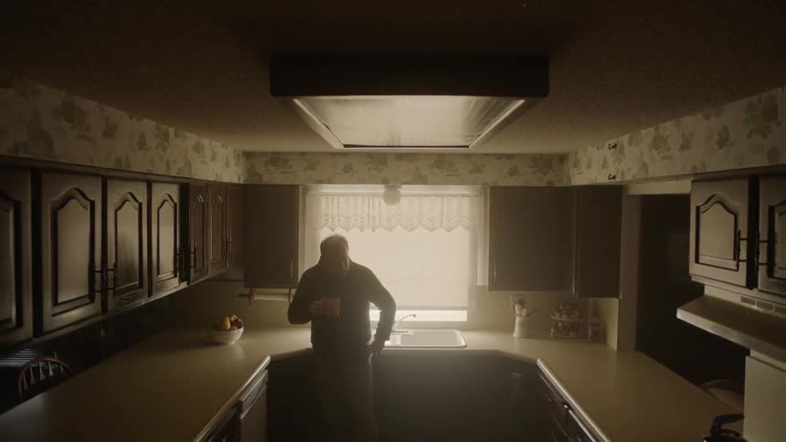 A man drinks coffee in the kitchen