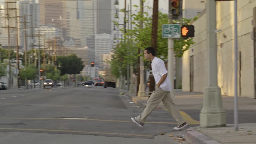 A boy crosses the intersection in the city
