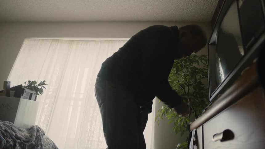 A man puts a tape inside the vcr