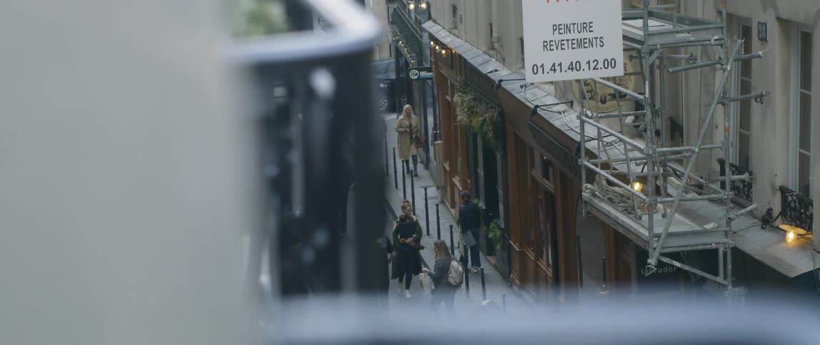 Pedestrians walk down the street