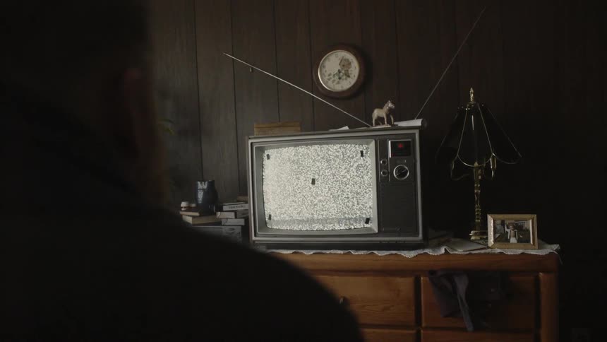 Television on a dresser with static flickering on it