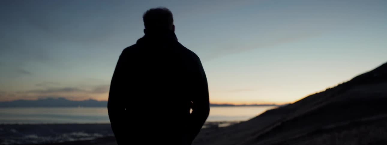 Man walks outside at dusk