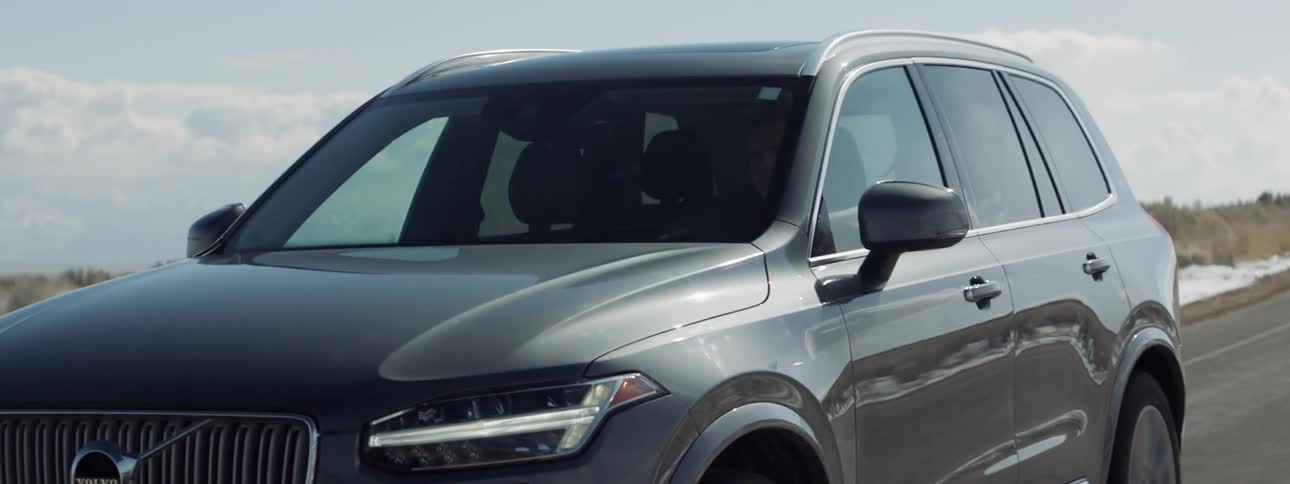 A volvo is driven on a rural road