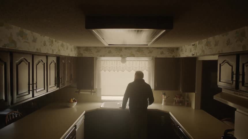 Man stands in front of a kitchen sink