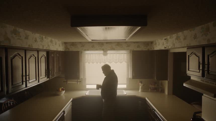 Man drinks coffee in a kitchen