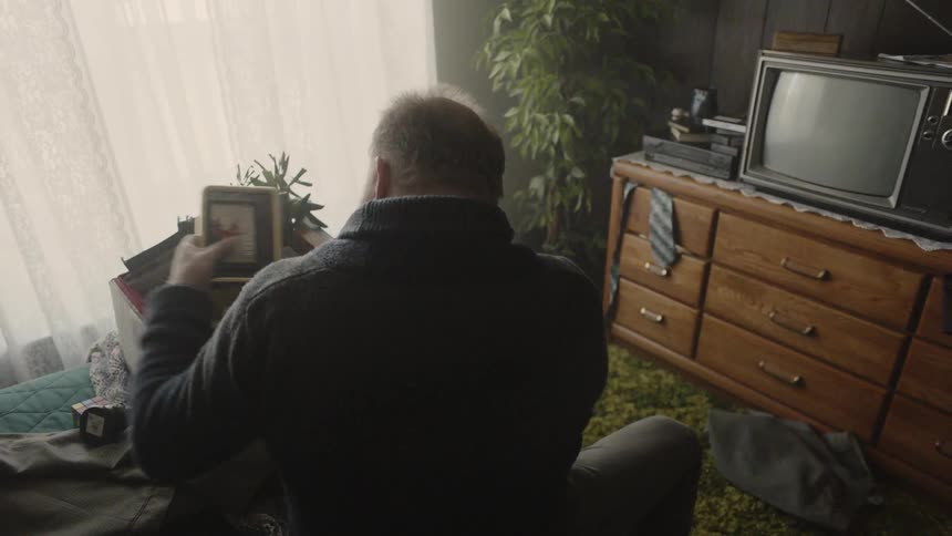 The man is removing items from a box