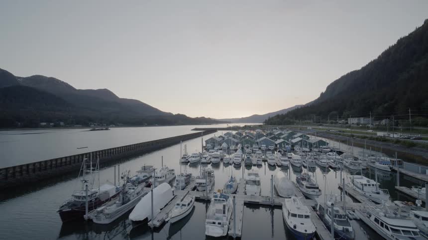 Slow pullback reveal of Juneau Harbor at sunset