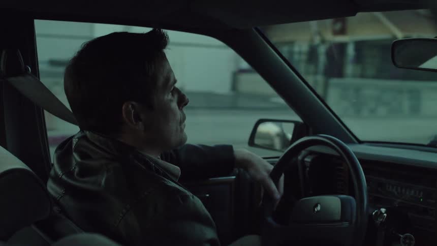Man drives a car on a city street