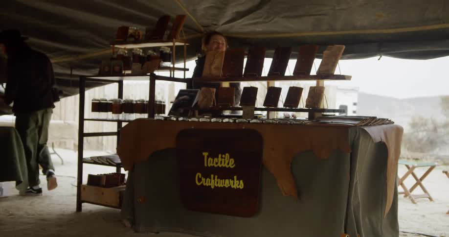 Man sells crafts in a tent