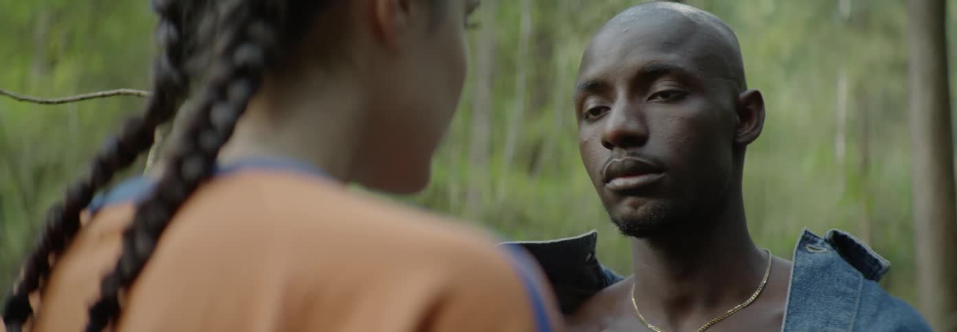 A man and woman stand face to face