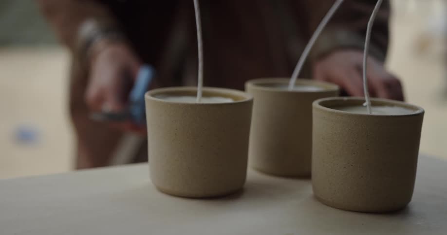 A woman trims candle wicks