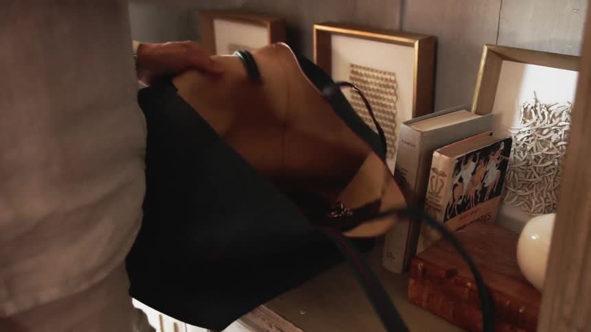 Woman puts items into a purse