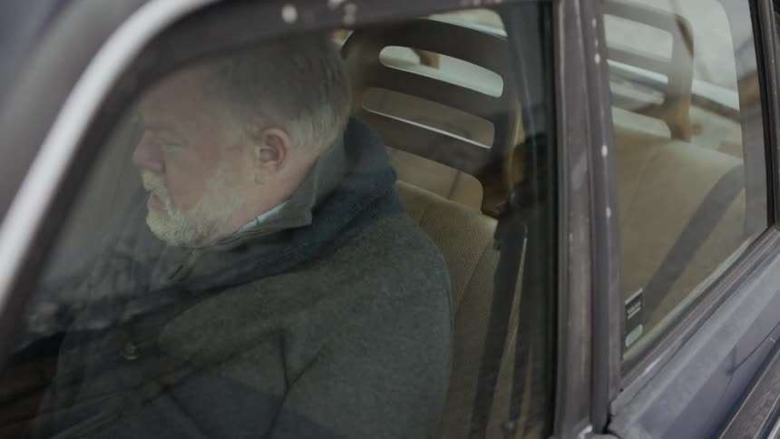 Man sits in a parked car