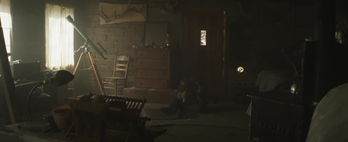 Man sitting on the floor of a dark room