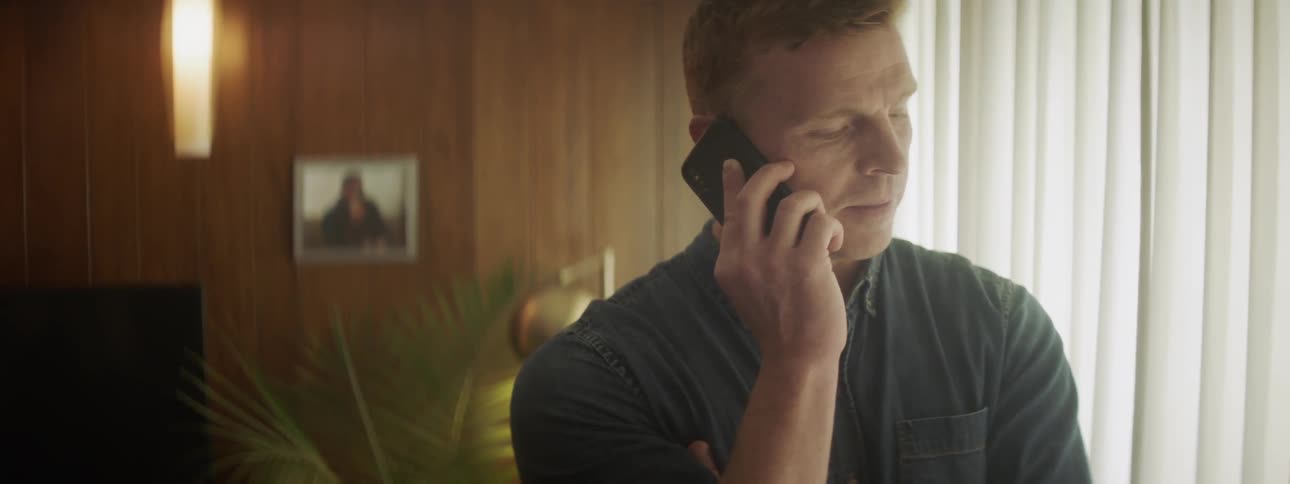 A man checks his phone briefly