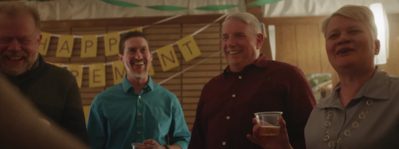 People smile at a retirement party